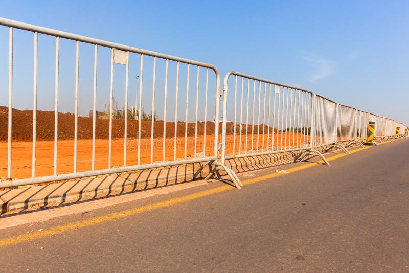 Portable fencing steel sections linked together on roadside at construction site. Portable fencing steel sections linked together on roadside at construction site.