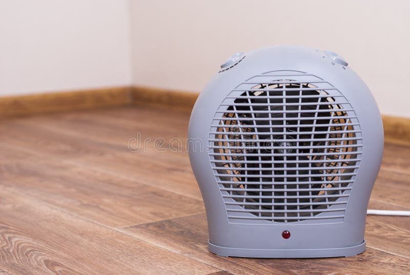 Portable electric heater fan type is on the floor. Portable electric heater fan type is on the floor