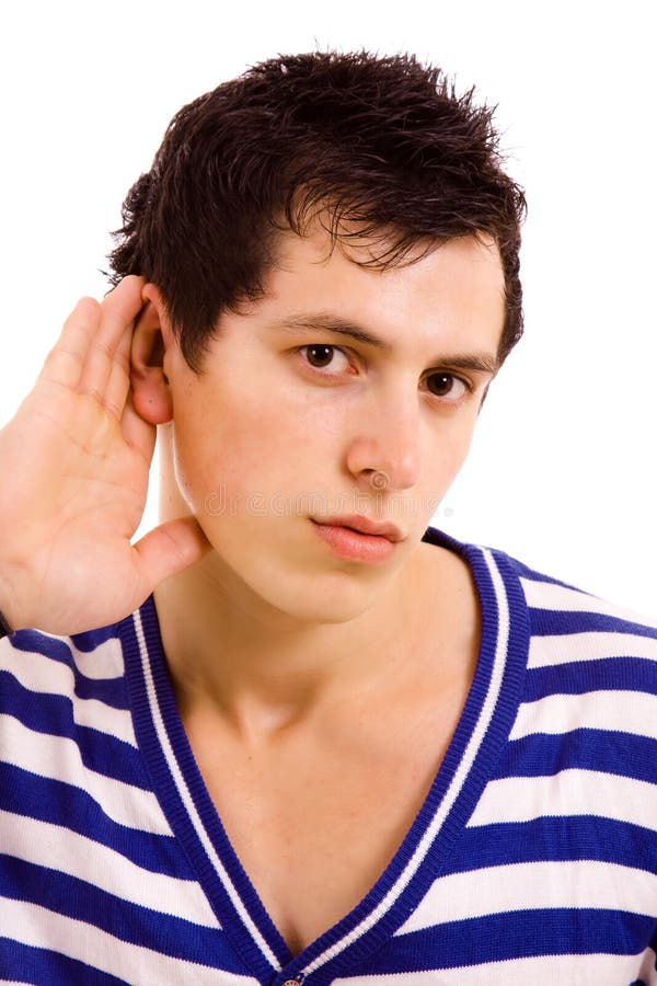 Young man with open hand gesturing hearing something on white background. Young man with open hand gesturing hearing something on white background