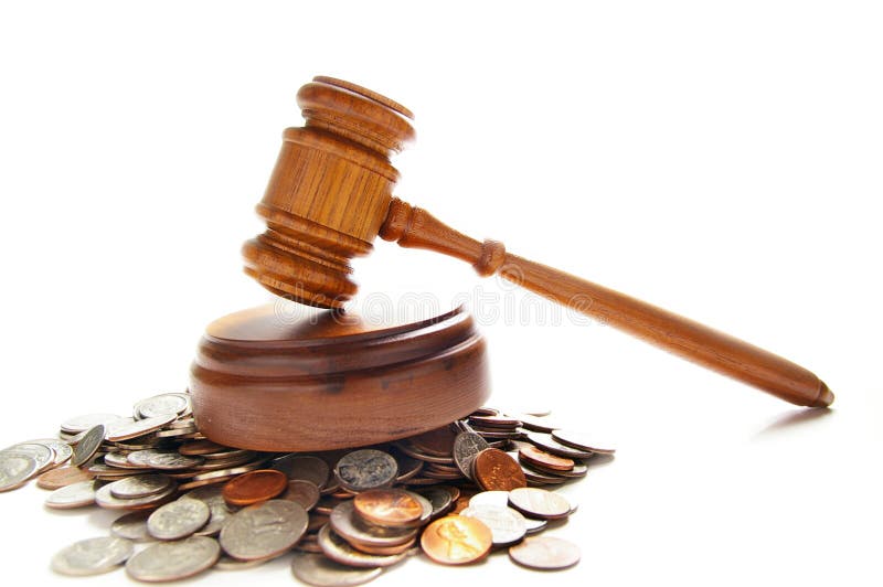 Judges law gavel on a pile of coins, over white. Judges law gavel on a pile of coins, over white