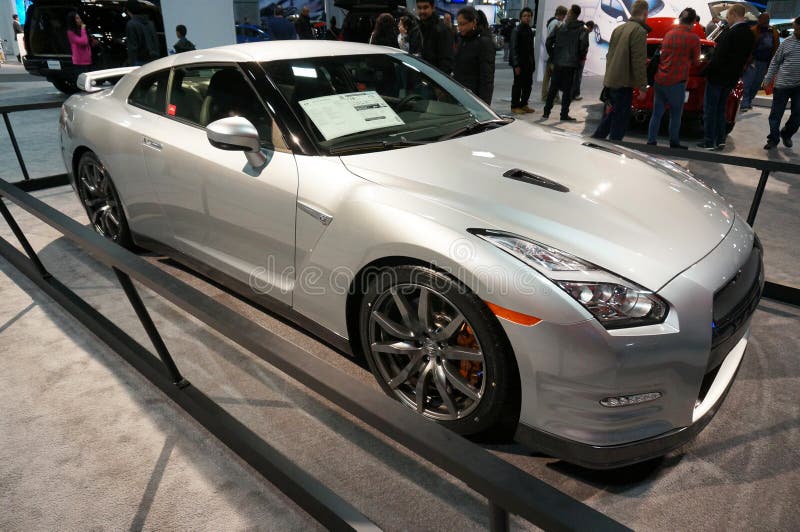 Photo of 2015 silver nissan gt-r premium sports car at the washington dc auto show at the washington dc convention center on 1/24/15. This car has a powerful v6 engine putting out 545 hp with a top speed of 191 mph. There are even more powerful versions available. This car is considered an affordable supercar with a price tag of $101770.00. Photo of 2015 silver nissan gt-r premium sports car at the washington dc auto show at the washington dc convention center on 1/24/15. This car has a powerful v6 engine putting out 545 hp with a top speed of 191 mph. There are even more powerful versions available. This car is considered an affordable supercar with a price tag of $101770.00.