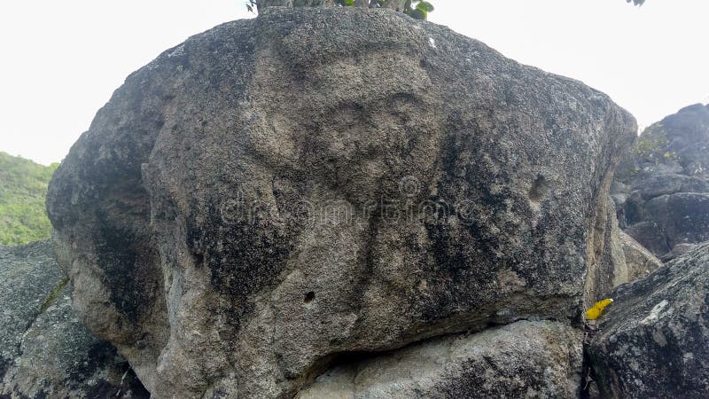 Closeup to an ancient petroglyph of human face at Colombian San Agustin archaeological park. antique pre columbus culture. Closeup to an ancient petroglyph of human face at Colombian San Agustin archaeological park. antique pre columbus culture.