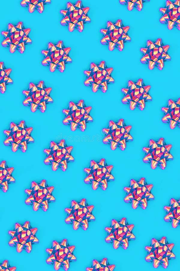 Psychedelic repeat ribbon bow pattern on pastel blue background. Vivid design composition for wrapping paper, Christmas, birthday or greetings card. Seamless bow stock images, royalty-free photos and pictures