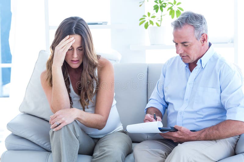 Psychiatrist advising depressed pregenat woman royalty free stock images Psychiatrist advising depressed pregenat woman royalty free stock images