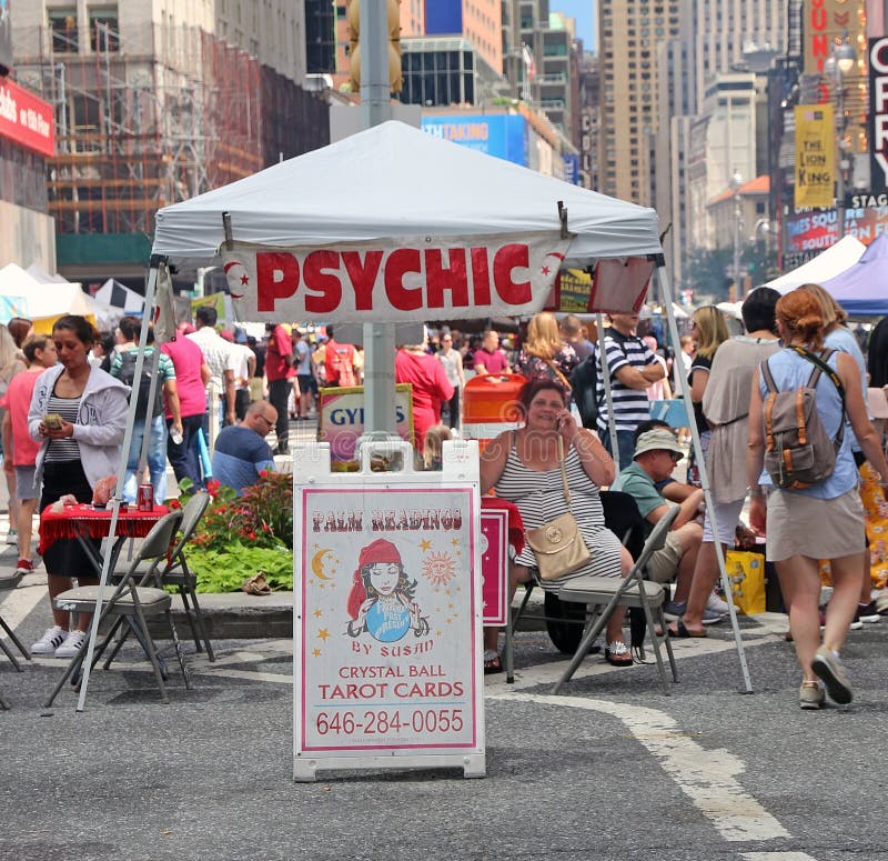A psychic Reader in a street fair, waiting for customers on 7th avenue in Times Square,Manhattan. NY. A psychic Reader in a street fair, waiting for customers on 7th avenue in Times Square,Manhattan. NY.