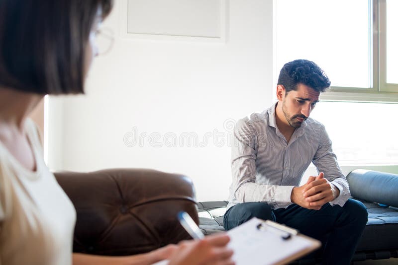 psychologist-taking-notes-during-therapy-session-stock-image-image