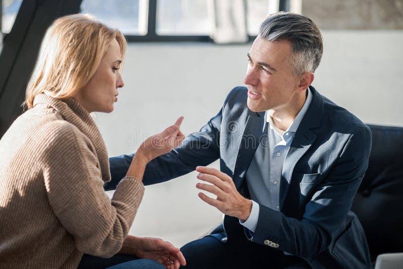 Psychologist Talking To a Client and Looking Friendly Stock Photo