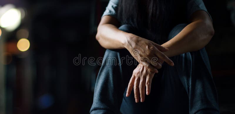 PTSD Mental health concept. Post Traumatic Stress Disorder. The depressed woman sitting alone on the floor in the dark room background. Film look. PTSD Mental health concept. Post Traumatic Stress Disorder. The depressed woman sitting alone on the floor in the dark room background. Film look.