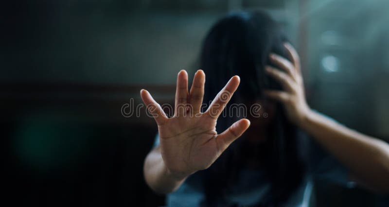 PTSD Mental health concept. Post Traumatic Stress Disorder. The depressed woman sitting alone on the floor and waving refusal to help from people in the dark room background. Film look. Soft focus. PTSD Mental health concept. Post Traumatic Stress Disorder. The depressed woman sitting alone on the floor and waving refusal to help from people in the dark room background. Film look. Soft focus.