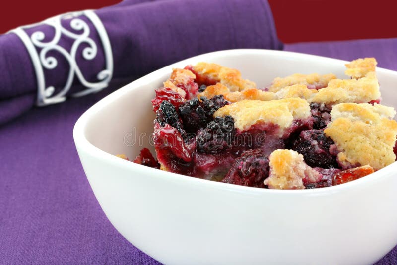 Berry cobbler, freshly made, in a white bowl. Berry cobbler, freshly made, in a white bowl.