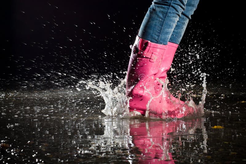 Girl jumping in the puddle. Girl jumping in the puddle