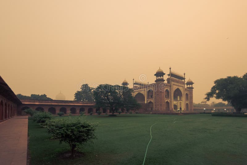 Entrance gate to the Taj Mahal before sunrise in  misty day. Entrance gate to the Taj Mahal before sunrise in  misty day