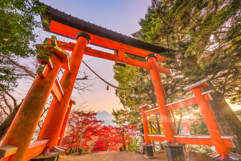 Fujiyoshida, Japan with the entrance gate to Arakura Sengen Shrine and Mt. Fuji in the distance during autumn season. Fujiyoshida, Japan with the entrance gate to Arakura Sengen Shrine and Mt. Fuji in the distance during autumn season.