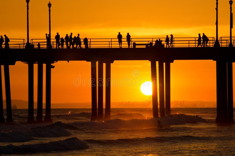 The sun setting behind the pier in Huntington Beach, CA. The sun setting behind the pier in Huntington Beach, CA.