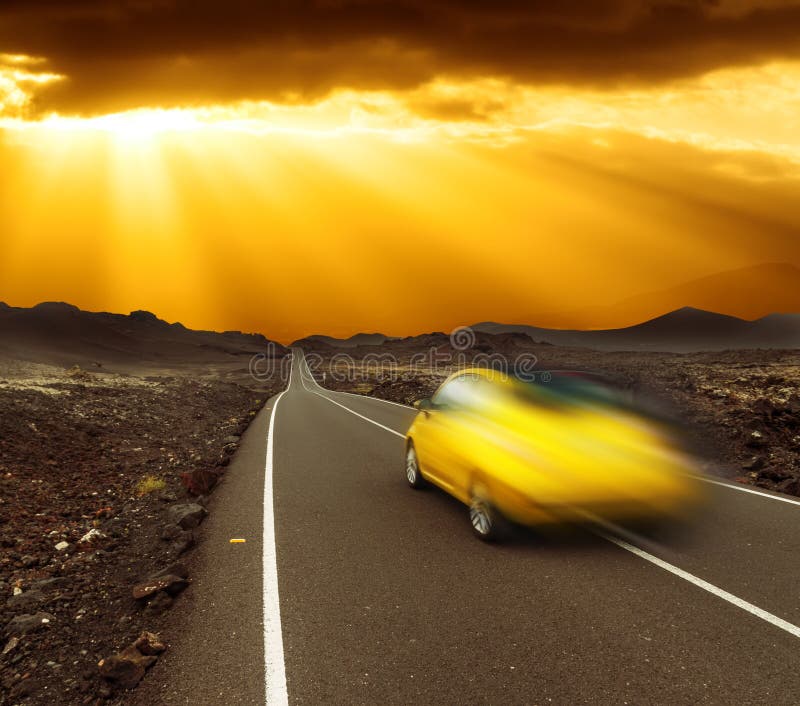 Yellow sunset over fast car and asphalt road, Canary island Lanzarote. Yellow sunset over fast car and asphalt road, Canary island Lanzarote