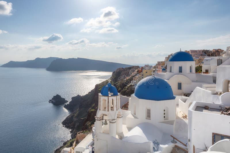 Puesta del sol sobre iglesias abovedadas azules en la caldera en Oia en la isla griega de Santorini foto de archivo libre de regalías Puesta del sol sobre iglesias abovedadas azules en la caldera en Oia en la isla griega de Santorini foto de archivo libre de regalías