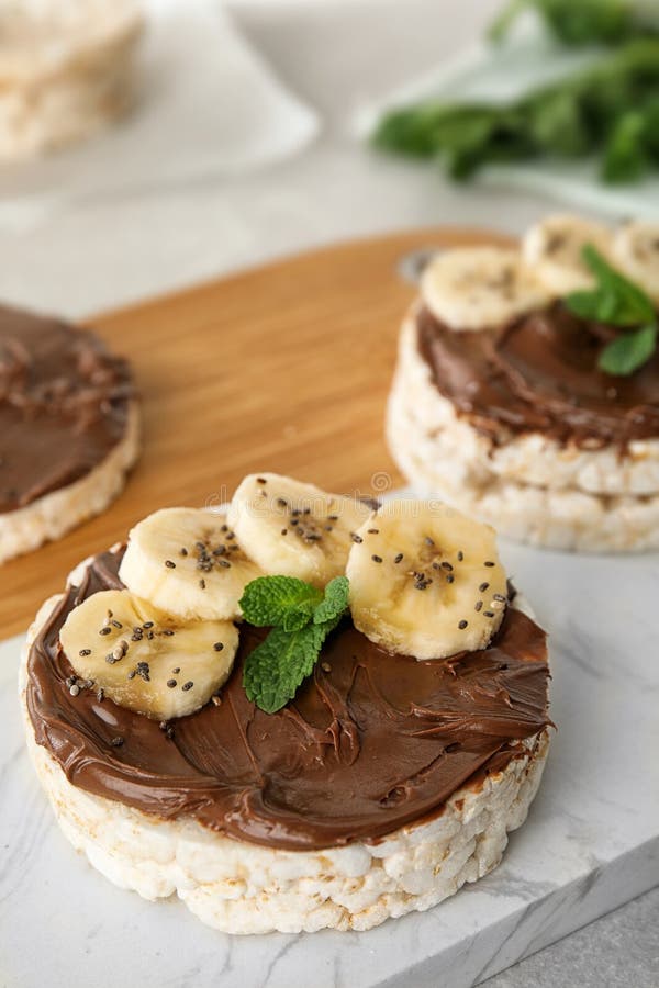 Puffed Rice Cakes with Chocolate Spread, Banana and Mint on Board