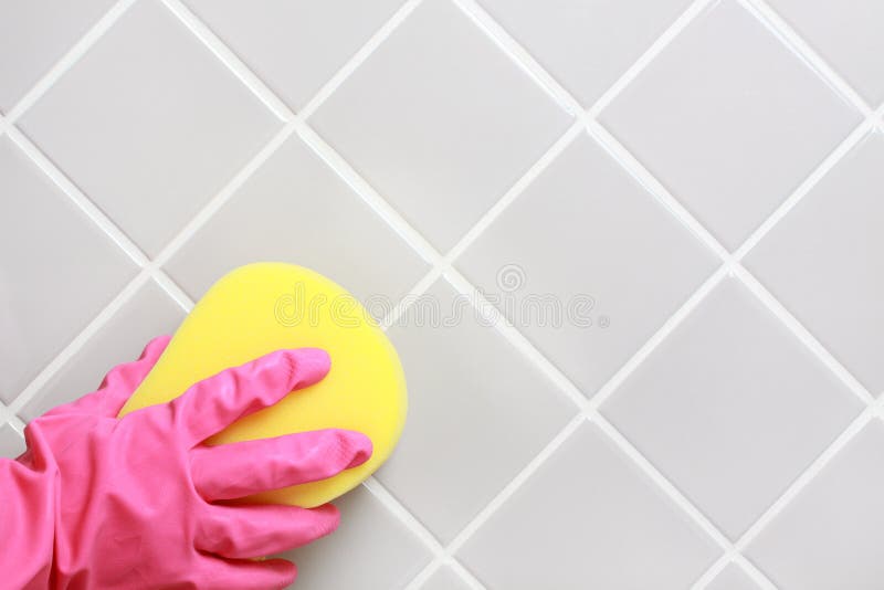 Hand and glove cleaning the bathroom tiles. Hand and glove cleaning the bathroom tiles.