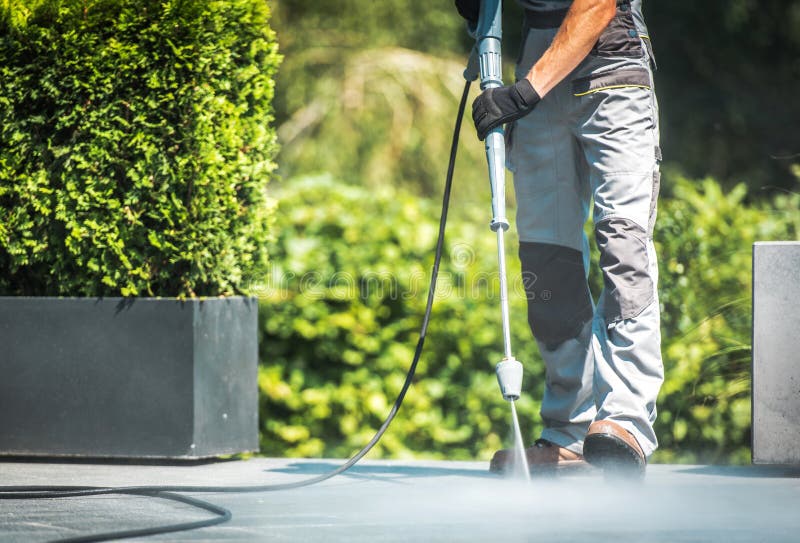 Patio Pressure Cleaning. Caucasian Men Washing His Concrete Floor Patio Using High Pressured Water Cleaner. Patio Pressure Cleaning. Caucasian Men Washing His Concrete Floor Patio Using High Pressured Water Cleaner.