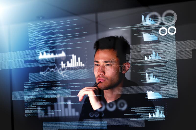 Pulling an all nighter. a focussed computer programmer working at his computer late at night. royalty free stock photography