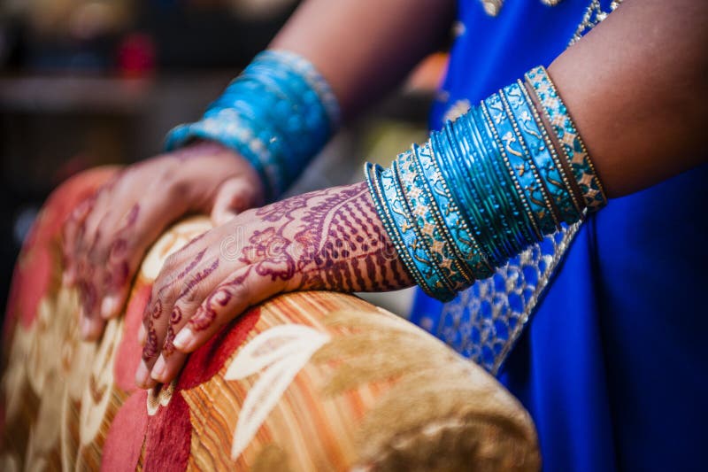 Indian bride's hands, fully decorated with henna decoration wearing bangle bracelet on her wedding day. Indian bride's hands, fully decorated with henna decoration wearing bangle bracelet on her wedding day
