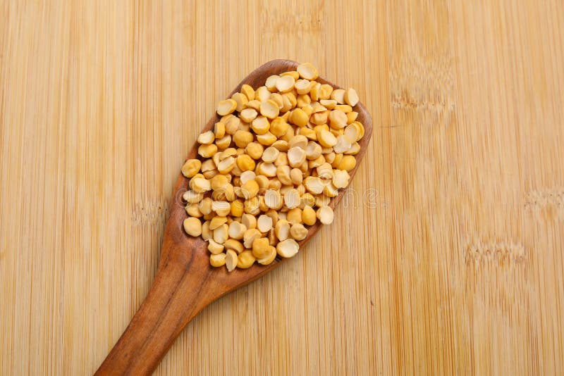 Dry and organic chickpea pulses in wooden spoon. Dry and organic chickpea pulses in wooden spoon.