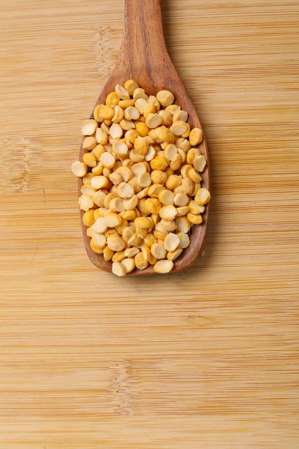 Dry and organic chickpea pulses in wooden spoon. Dry and organic chickpea pulses in wooden spoon.