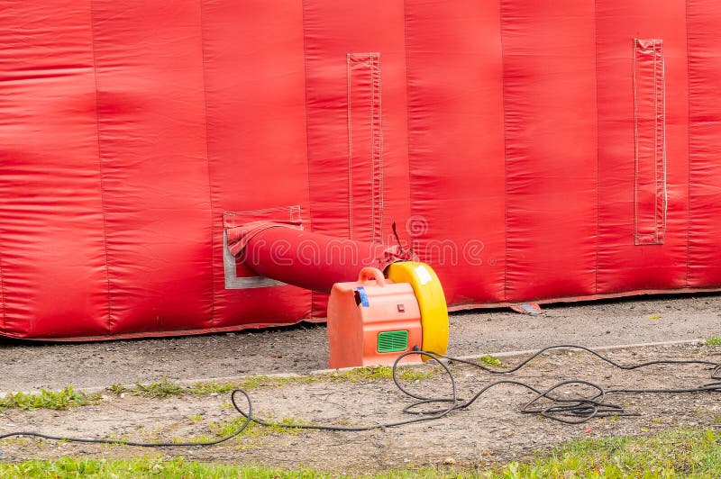 Pump for inflating a children&#x27;s bouncy castle. High quality photo