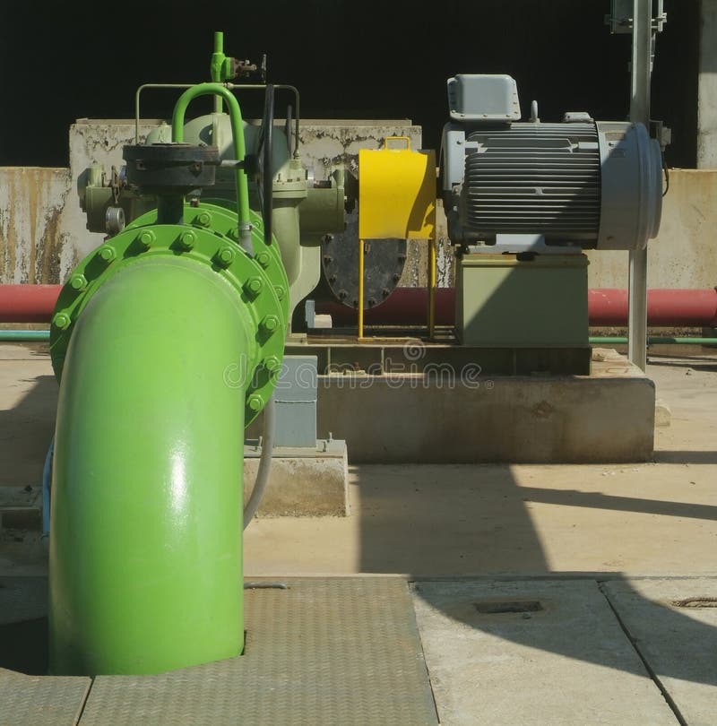 Pumps, valves and green steel pipes at industrial cooling tower. Pumps, valves and green steel pipes at industrial cooling tower.