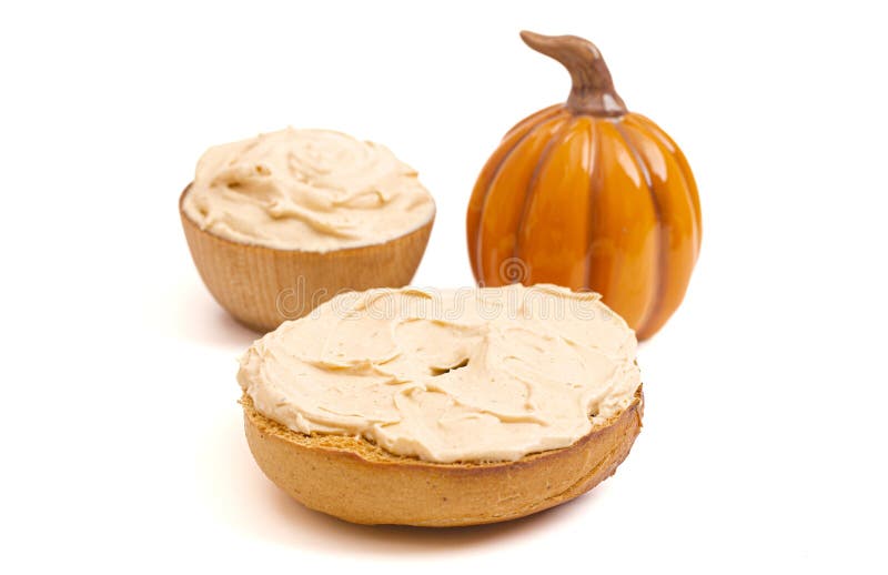 A Pumpkin Bagel with Pumpkin Cream Cheese Spread Isolated on a White