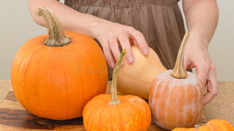 Female hands making butternut squash noodles with a vegetable peeler.Top  view Stock Photo - Alamy