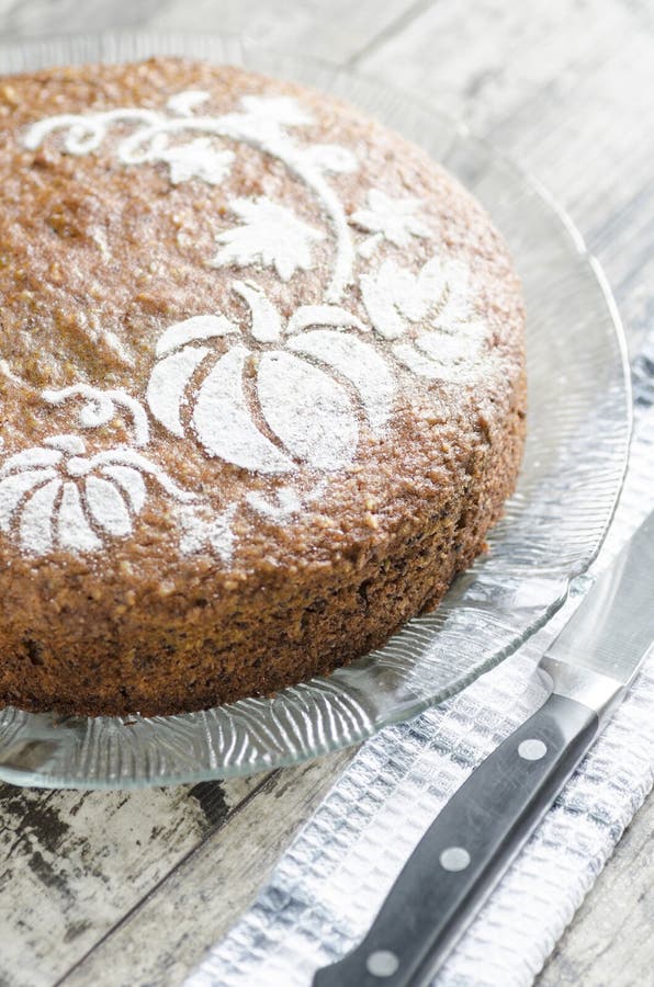 Pumpkin cake on glass plate and towel