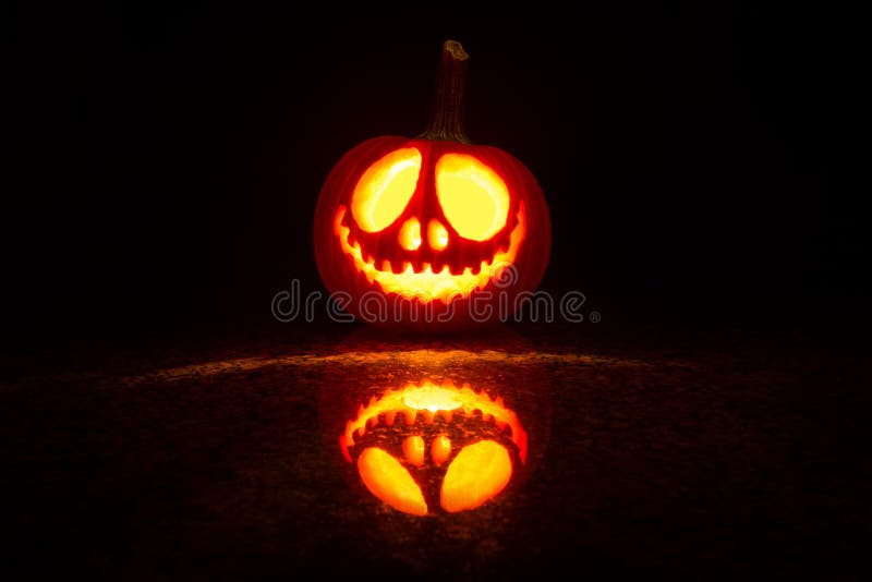 pumpkin carved with candle light for halloween. pumpkin carved with candle light for halloween