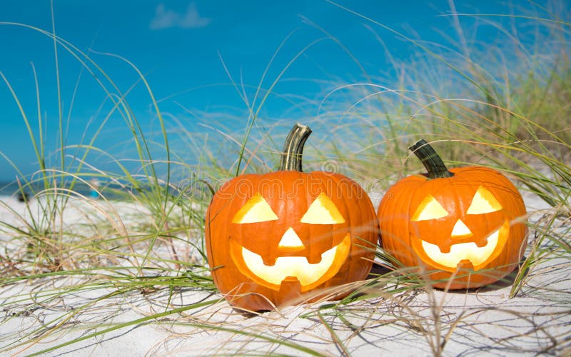 Pumpkin Halloween Jack-o-lantern party on the beach. Trick or treat Happy Halloween. Autumn season. On background ocean. Autumn in Florida. Fall season. Copy space.