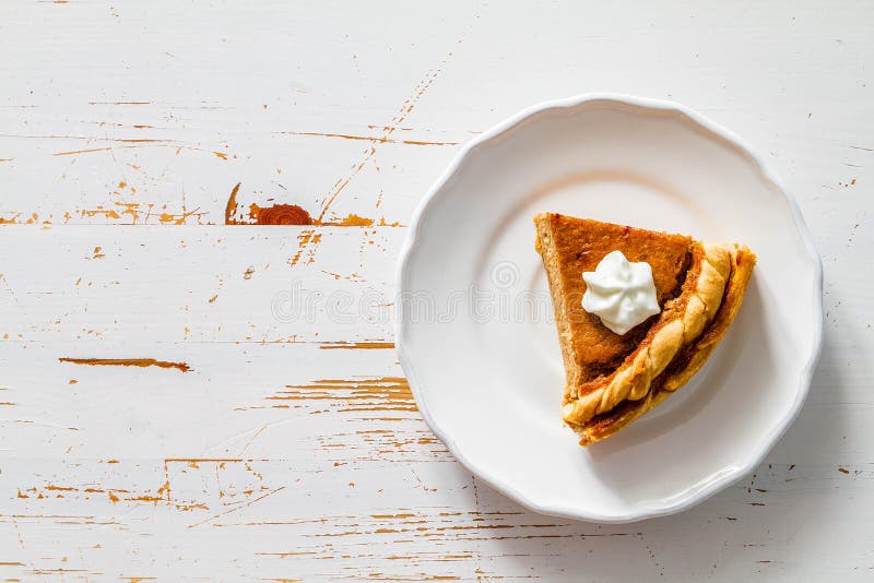 Pumpkin pie, white wood background