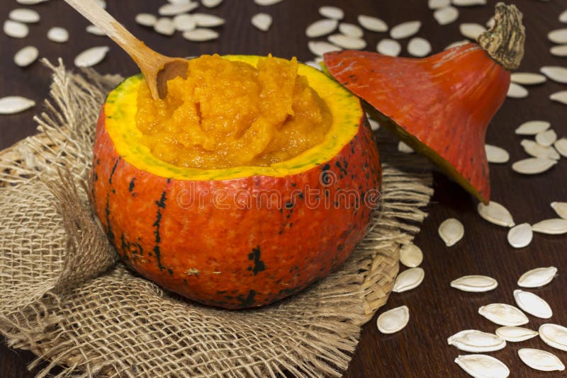 Pumpkin Porridge in an Orange Pumpkin on Burlap. Pumpkin Seeds on the