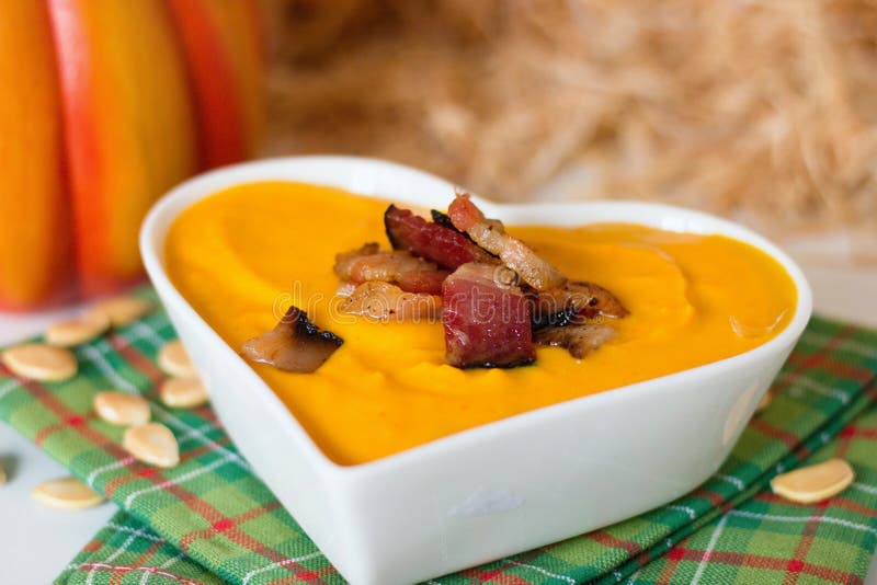 Pumpkin soup with bacon in heart shaped bowl