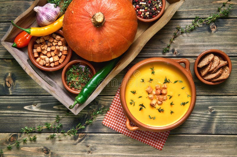 Pumpkin Soup in Ceramic Bowl on Rustic Wood Served with Thyme an Stock ...