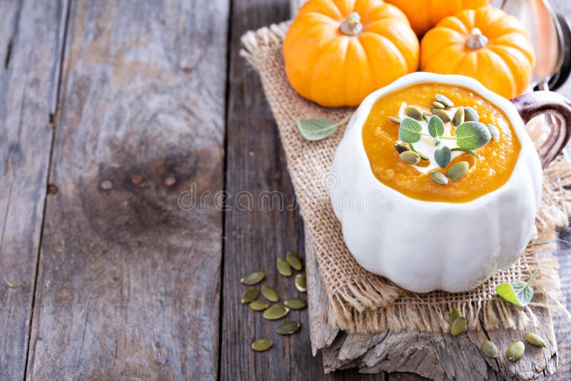 Pumpkin Soup with Cream, Herbs and Seeds Stock Image Image of bread