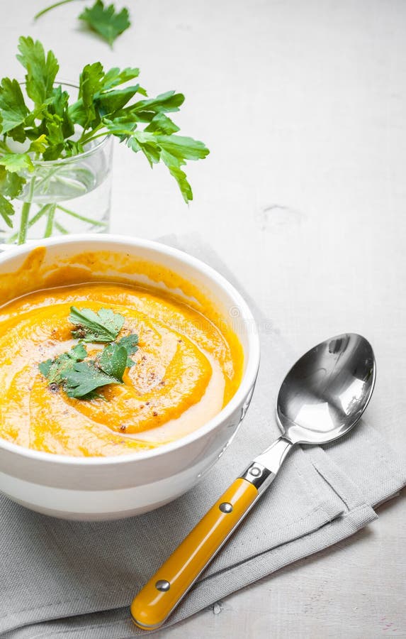 Pumpkin soup with parsley background