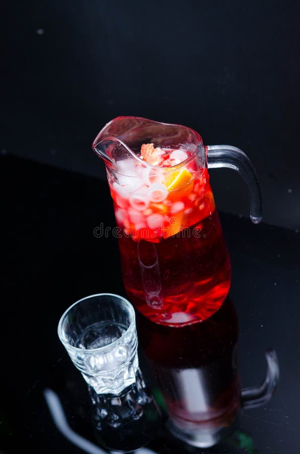 Punch with fruits and ice in glasses and pincher. Homemade refreshing fruit sangria over rustic wooden table, stock image Punch with fruits and ice in glasses and pincher. Homemade refreshing fruit sangria over rustic wooden table, stock image