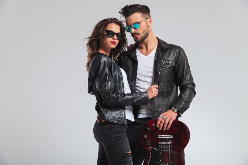 Rock and Roll Man with Guitar on Shoulder Embracing Woman Stock Image -  Image of leather, hold: 99189689