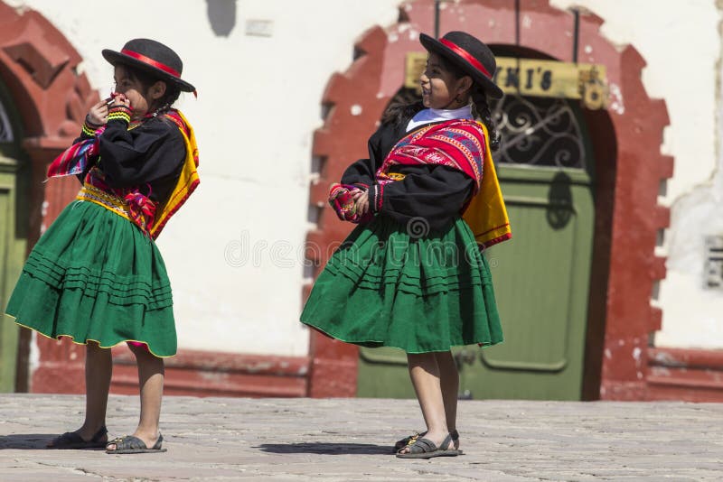 Puno, Peru - August 20, 2016: Native people from peruvian city dressed in colorful clothing perform traditional dance in a religious celebration. Peru, South America. Puno, Peru - August 20, 2016: Native people from peruvian city dressed in colorful clothing perform traditional dance in a religious celebration. Peru, South America.