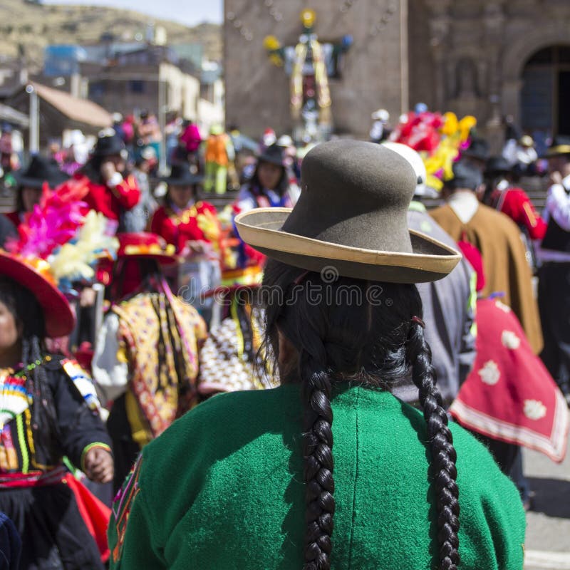 Puno, Peru - August 20, 2016: Native people from peruvian city dressed in colorful clothing perform traditional dance in a religious celebration. Peru, South America. Puno, Peru - August 20, 2016: Native people from peruvian city dressed in colorful clothing perform traditional dance in a religious celebration. Peru, South America.