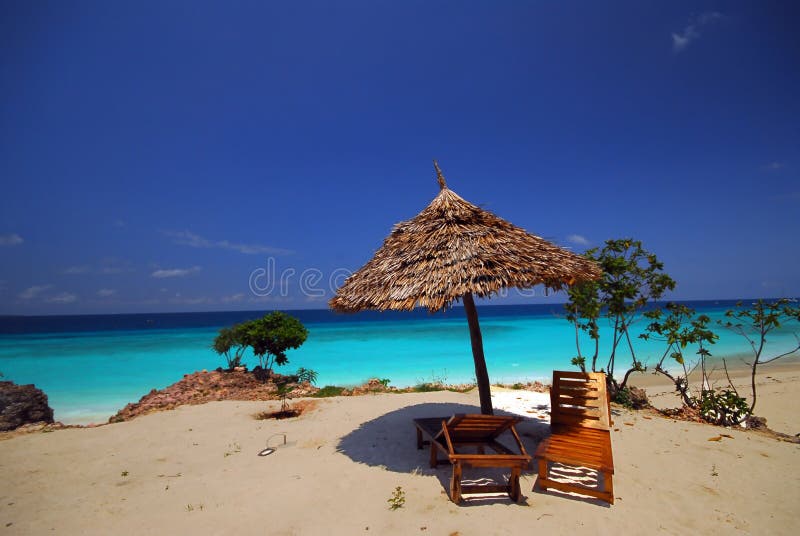 lonely sunshade with 2 beds on the beach, zanzibar africa. lonely sunshade with 2 beds on the beach, zanzibar africa