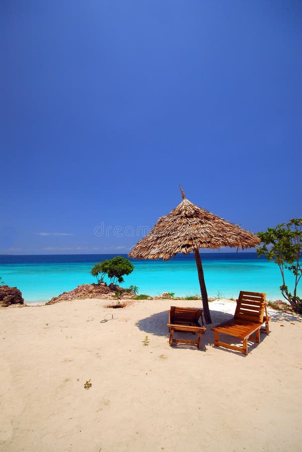 lonely sunshade with 2 beds on the beach, zanzibar africa. lonely sunshade with 2 beds on the beach, zanzibar africa