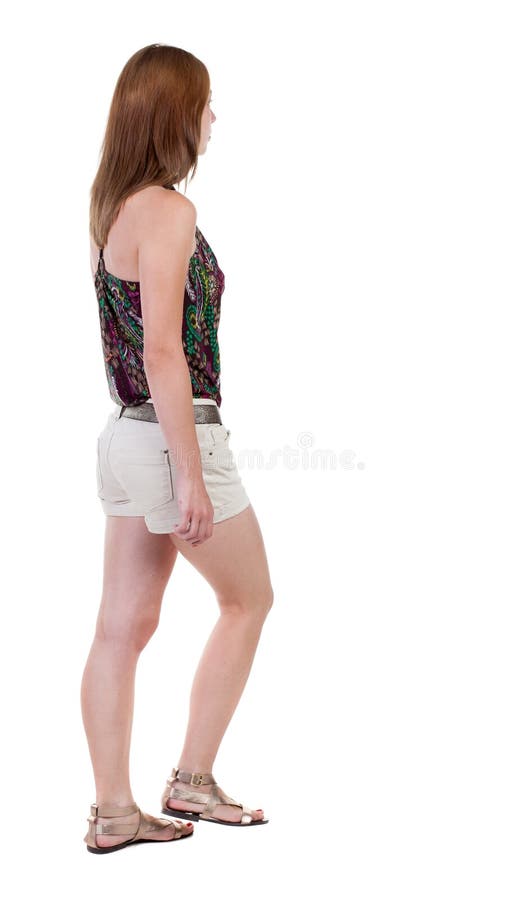 Punto di vista posteriore della donna di camminata in breve bella ragazza bionda dentro fotografia stock