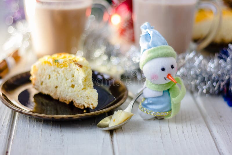 Winter snowman sitting near the plate with christmas pie. Winter snowman sitting near the plate with christmas pie.