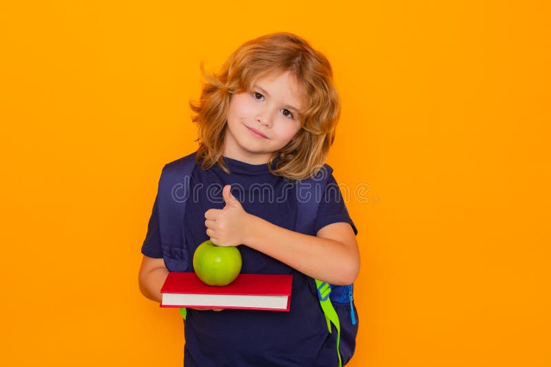 Pupil, nerd schoolboy. School child with book isolated on yellow background. Elementary school. Pupil go study. Clever stock photos