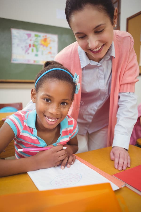 Pupil and Teacher at Desk in Classroom Stock Image Image of class